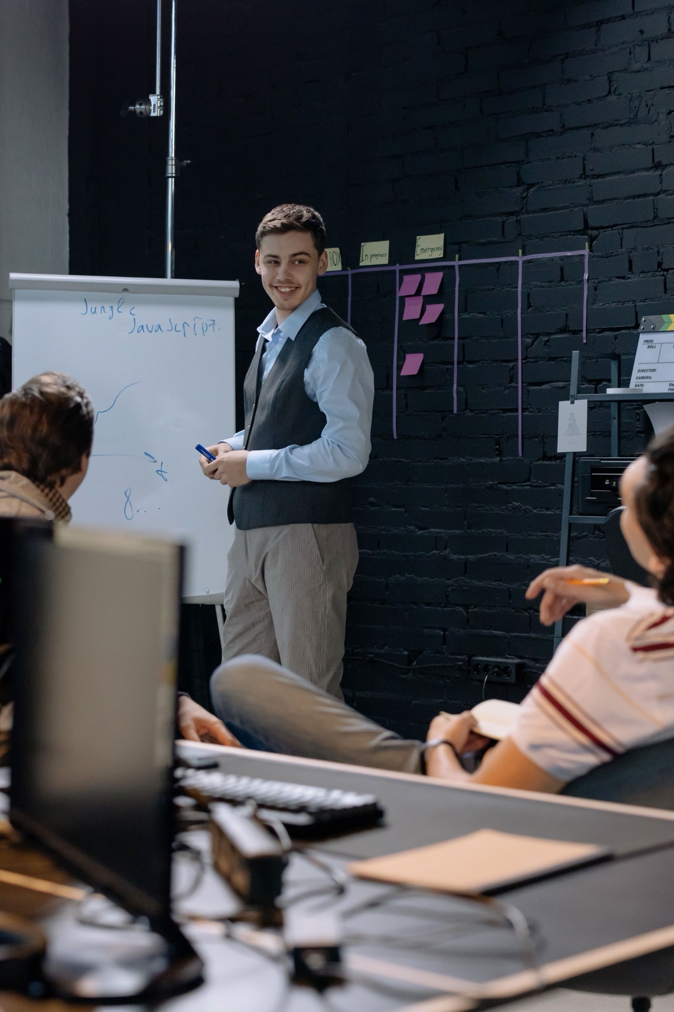 The team during a morning brief at the whiteboard